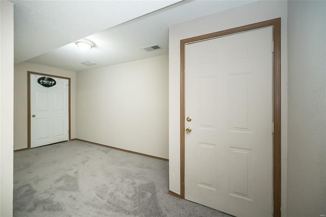 entrance foyer featuring light carpet