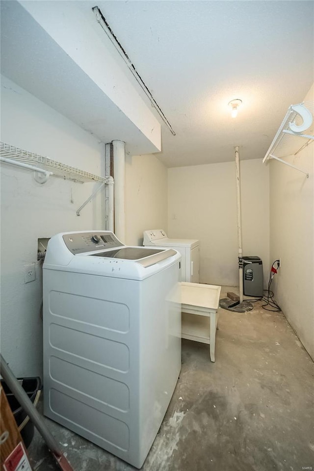 clothes washing area with washer and dryer