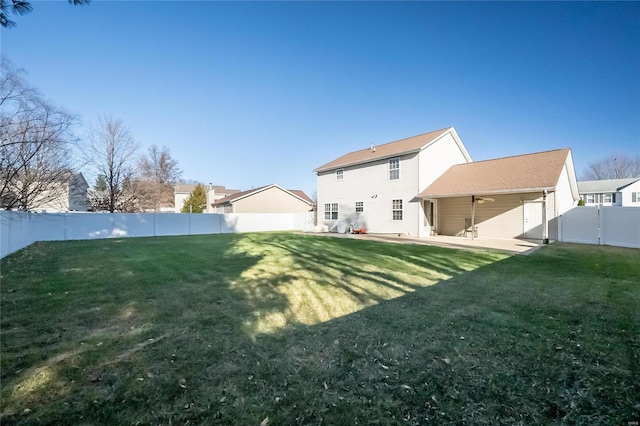 rear view of house featuring a patio area and a yard