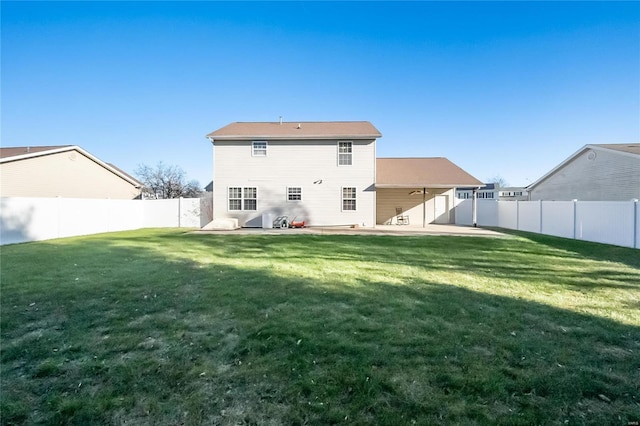 rear view of house with a lawn and a patio