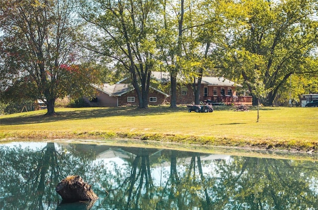 exterior space with a yard and a water view