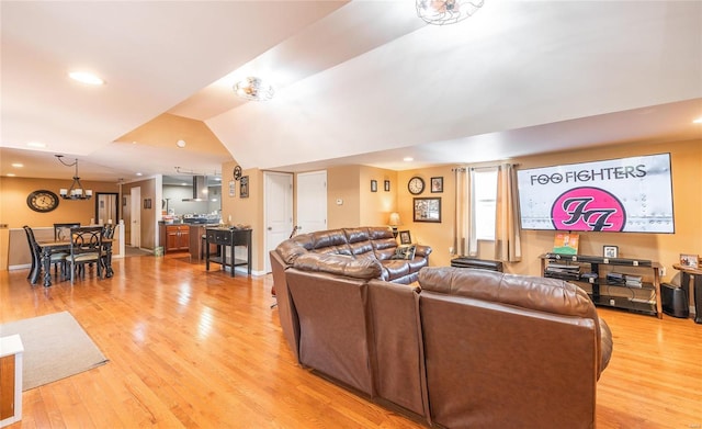 living room with light hardwood / wood-style flooring and lofted ceiling