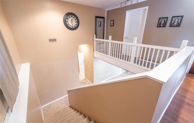 staircase featuring hardwood / wood-style flooring