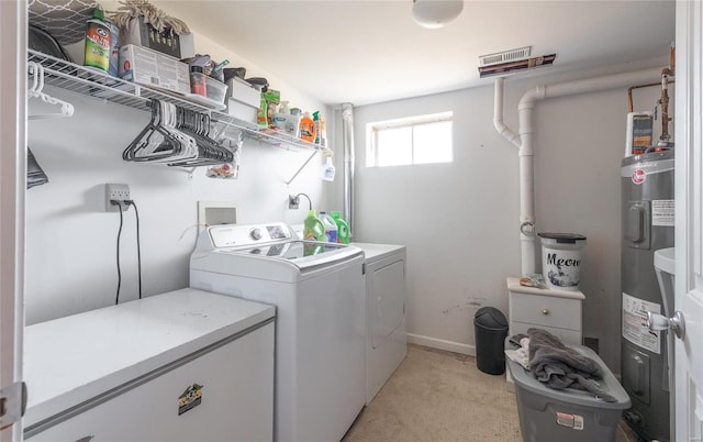 clothes washing area featuring electric water heater, separate washer and dryer, and light carpet