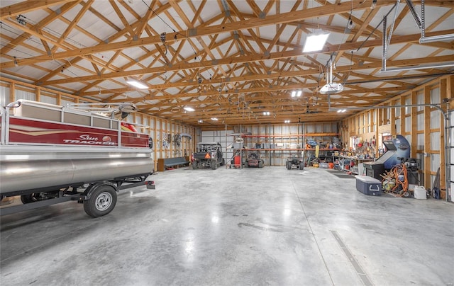 garage with a workshop area and a garage door opener