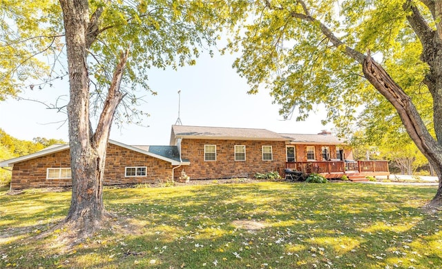 back of property with a yard and a deck