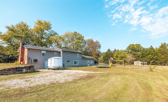 view of yard featuring a playground, a storage unit, and a trampoline