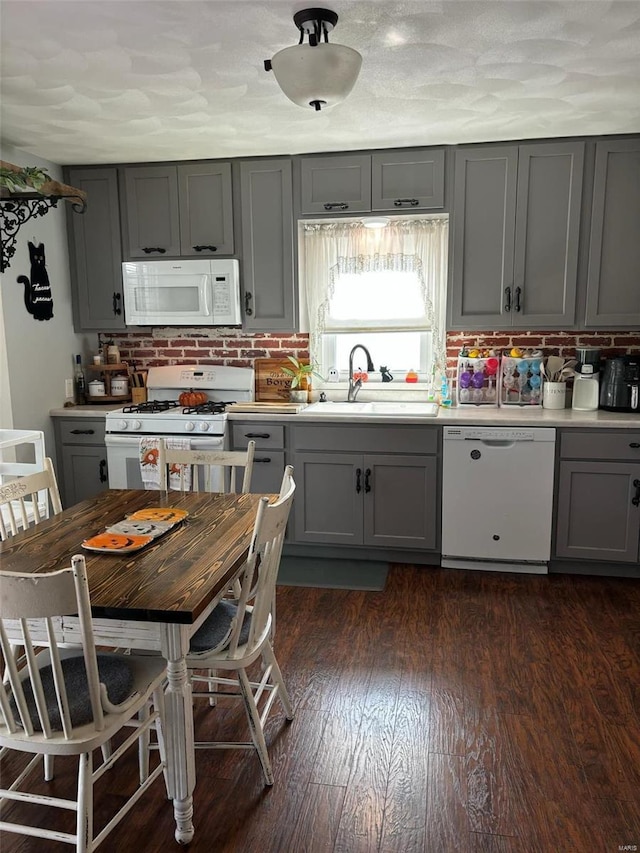 kitchen featuring white appliances and gray cabinets