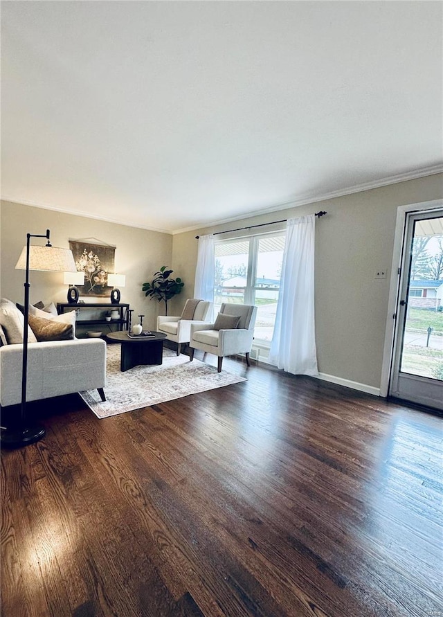 living room with hardwood / wood-style floors, a wealth of natural light, and crown molding