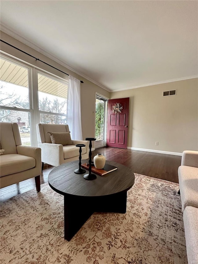 living room with hardwood / wood-style floors and ornamental molding