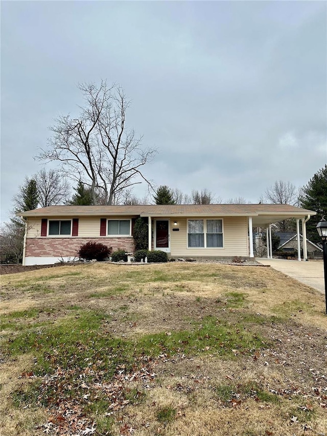 ranch-style home with a front yard and a carport