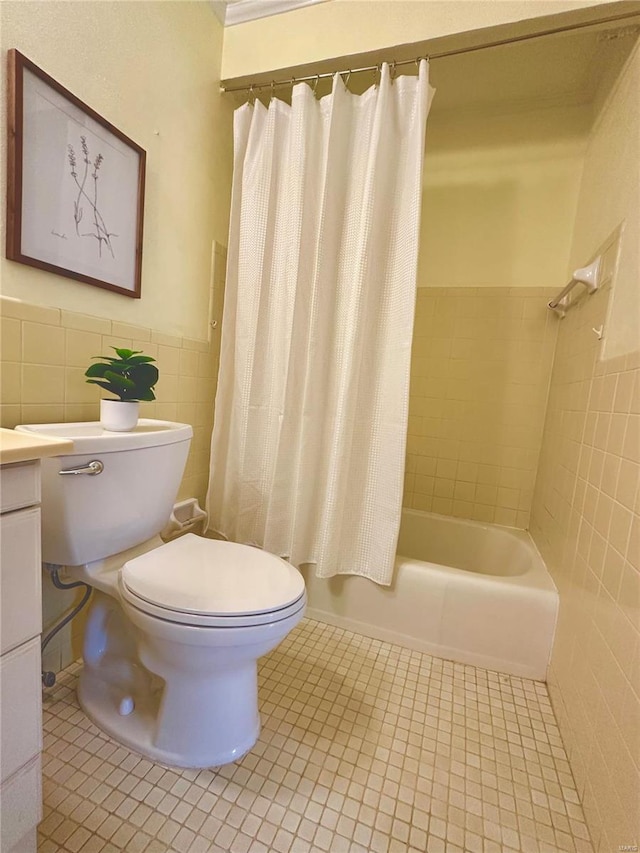 full bathroom featuring vanity, tile patterned flooring, toilet, shower / bath combo with shower curtain, and tile walls