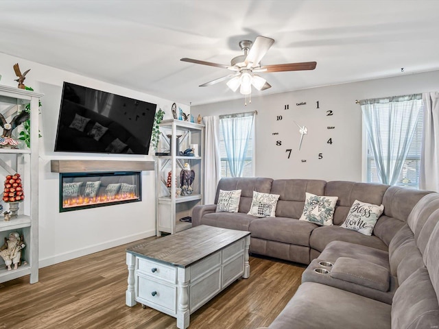 living room featuring hardwood / wood-style flooring and ceiling fan