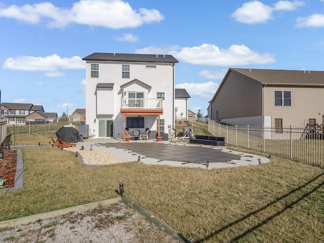 rear view of house with a lawn and a patio