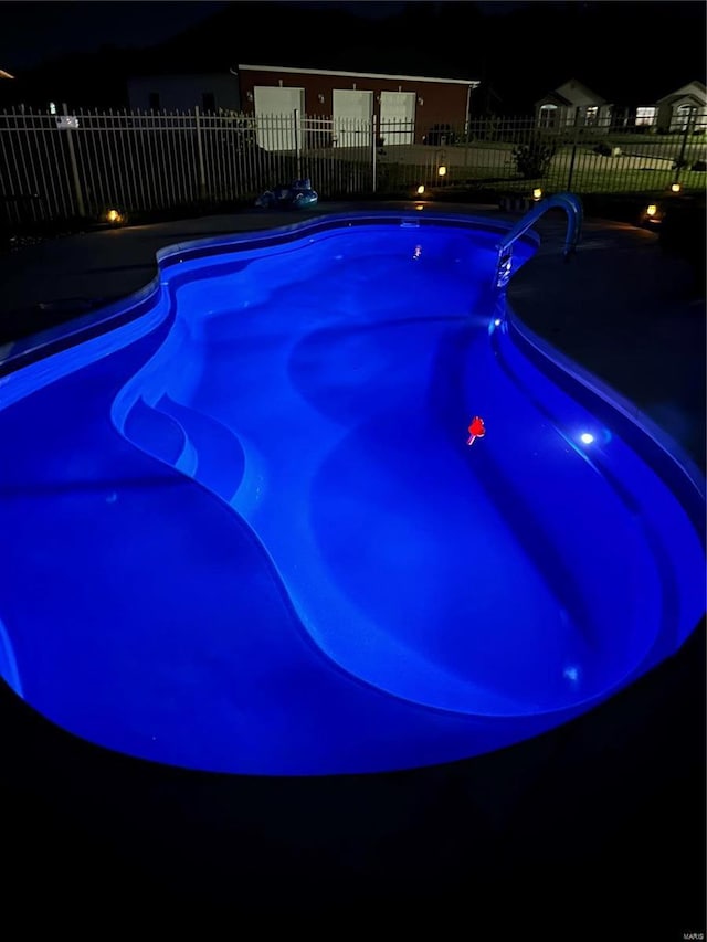 view of pool at night