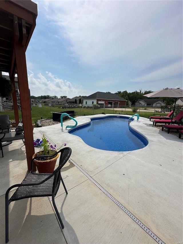 view of swimming pool with a patio area