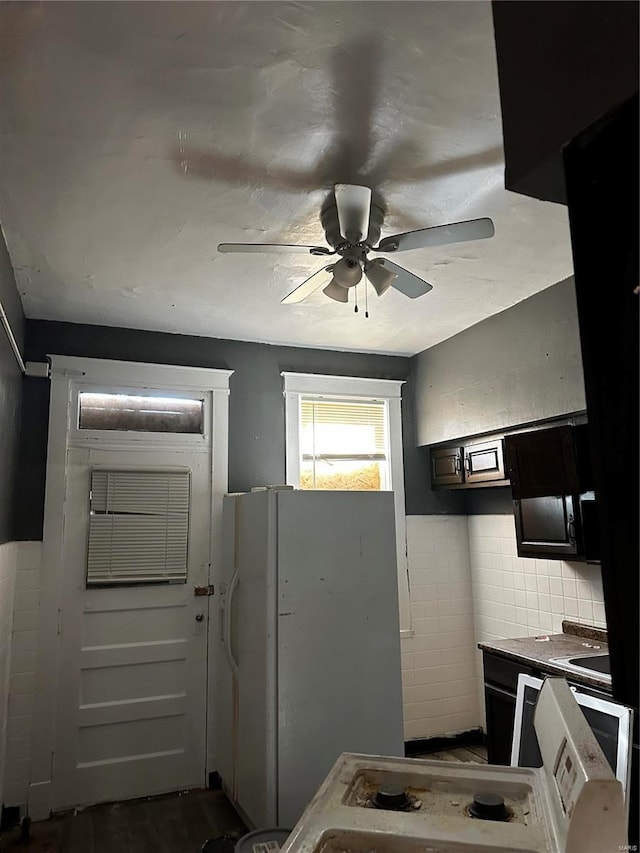 kitchen featuring tile walls, ceiling fan, and white refrigerator with ice dispenser