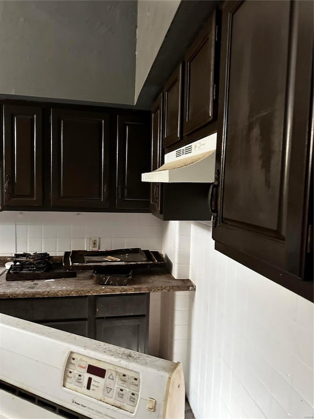 kitchen with decorative backsplash and dark brown cabinets