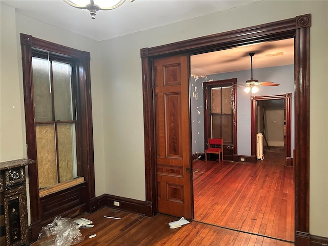 hallway featuring dark hardwood / wood-style floors and radiator heating unit