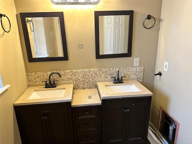 bathroom featuring vanity and tasteful backsplash