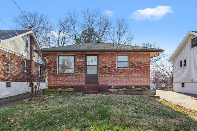 bungalow-style home featuring a front yard