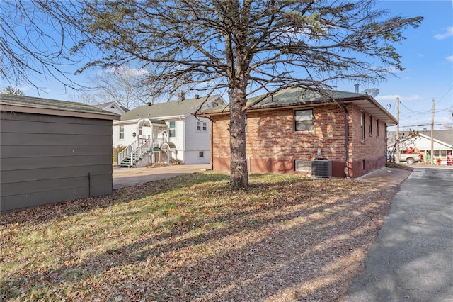 rear view of house featuring central AC