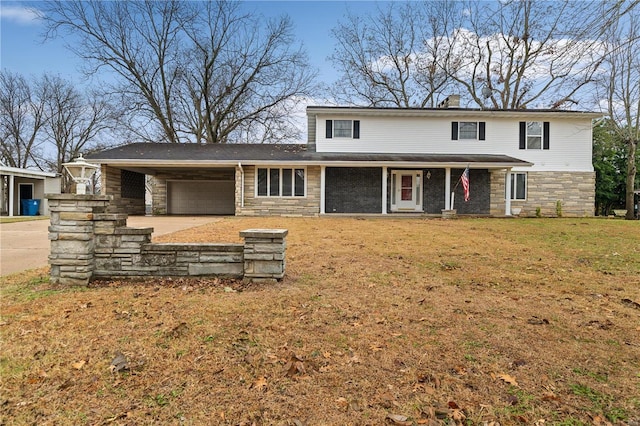 view of front of home with a front yard and a garage