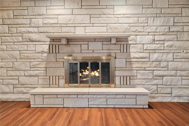 details with a fireplace and hardwood / wood-style flooring