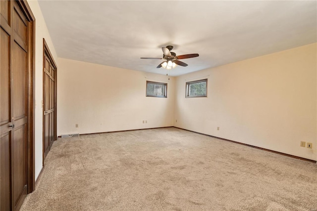 unfurnished bedroom with light carpet and ceiling fan