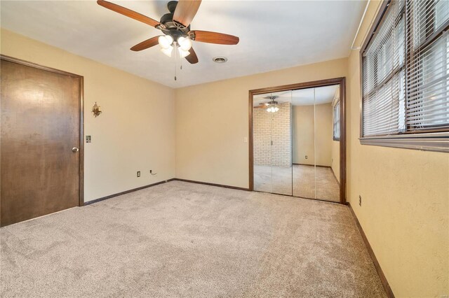 carpeted spare room with ceiling fan