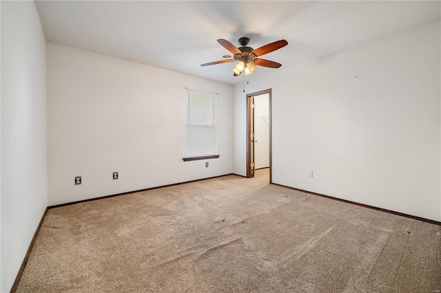 empty room with light colored carpet and ceiling fan