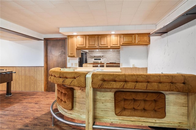 interior space with dark hardwood / wood-style floors and wooden walls