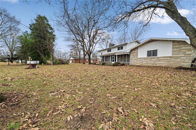 view of yard featuring a sunroom