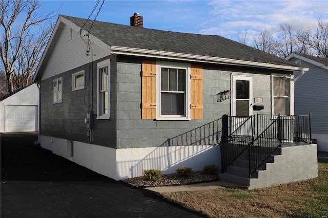 view of front facade with an outbuilding and a garage