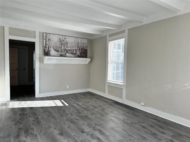 unfurnished dining area featuring beam ceiling and dark hardwood / wood-style floors