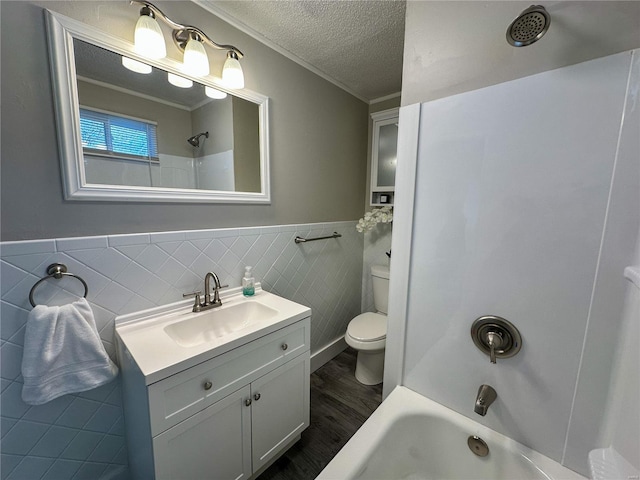 full bathroom with crown molding, wood-type flooring, and tile walls