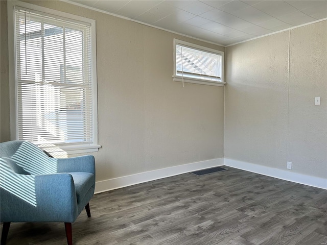 sitting room with dark hardwood / wood-style flooring and ornamental molding