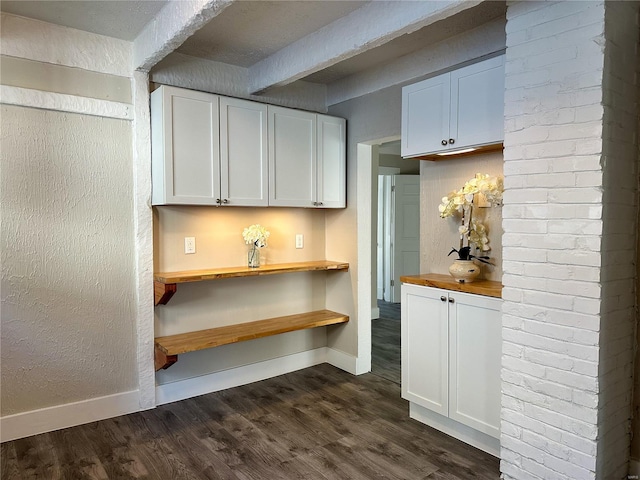 kitchen featuring dark hardwood / wood-style floors, white cabinetry, and butcher block countertops