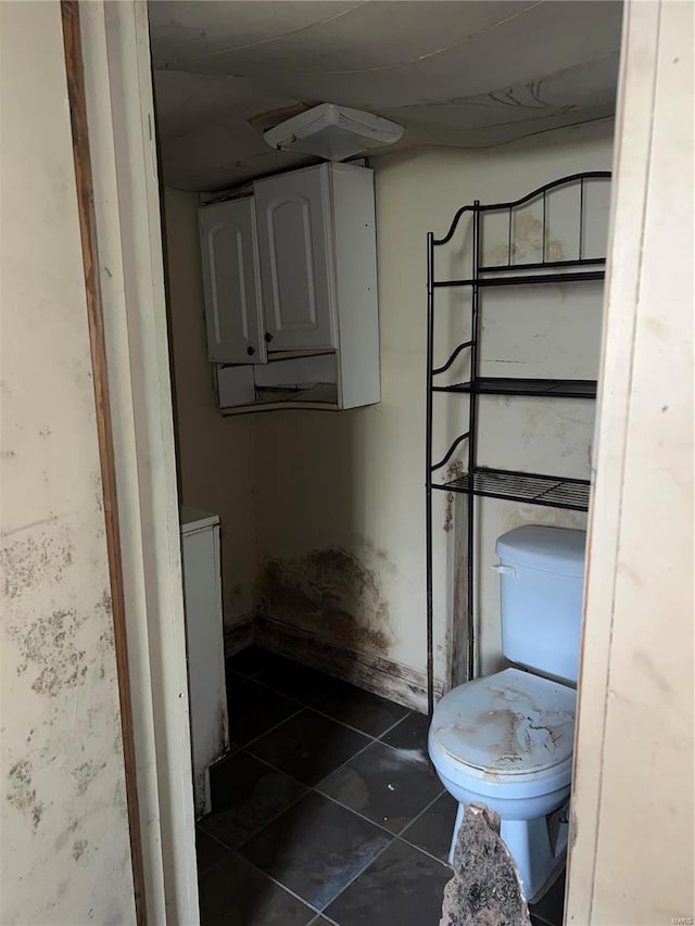 bathroom with toilet and tile patterned floors