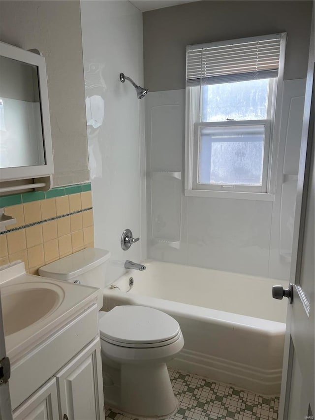 full bathroom with shower / bathing tub combination, vanity, toilet, and tile walls