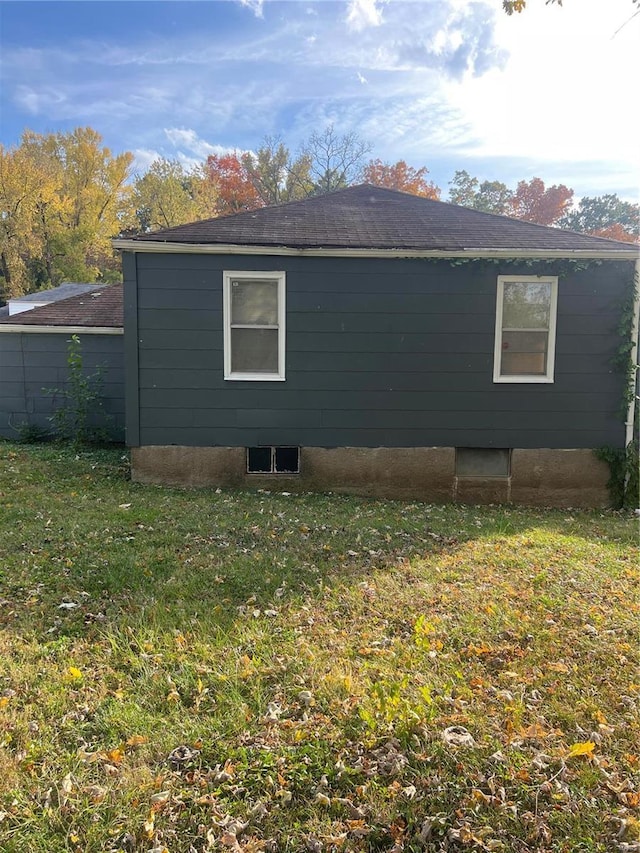 view of side of home with a lawn