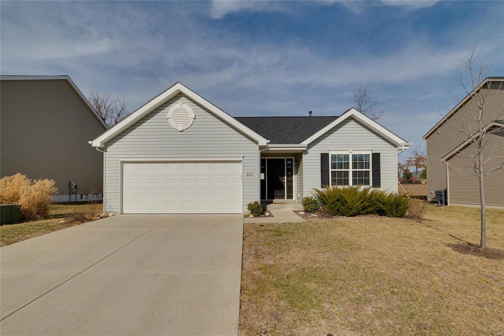 single story home featuring a garage and a front yard