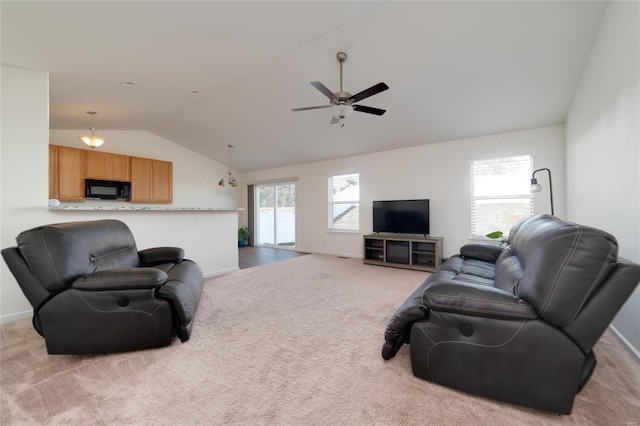 living room with lofted ceiling, light colored carpet, and ceiling fan