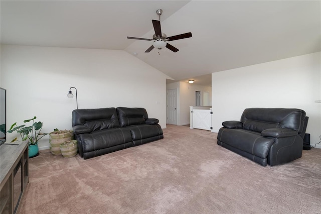 living room with ceiling fan, vaulted ceiling, and carpet