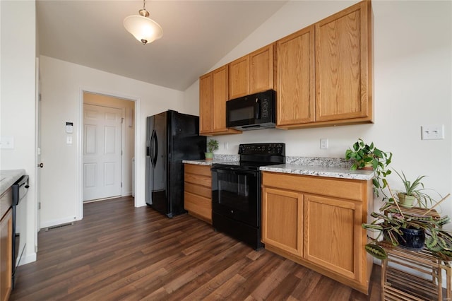 kitchen featuring lofted ceiling, light stone counters, dark hardwood / wood-style flooring, and black appliances