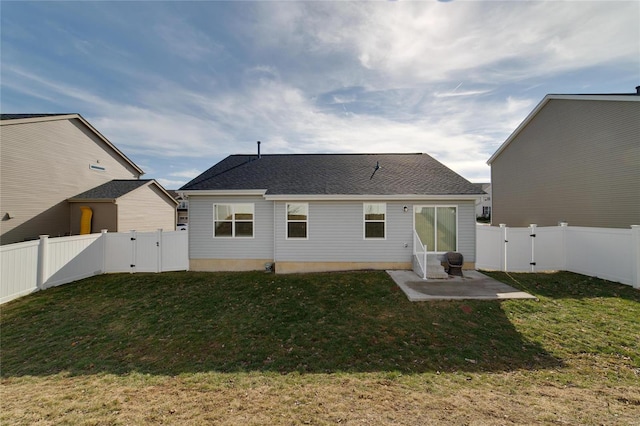 back of house featuring a yard and a patio area