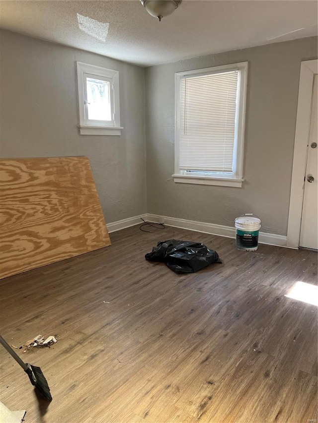 unfurnished room with hardwood / wood-style flooring