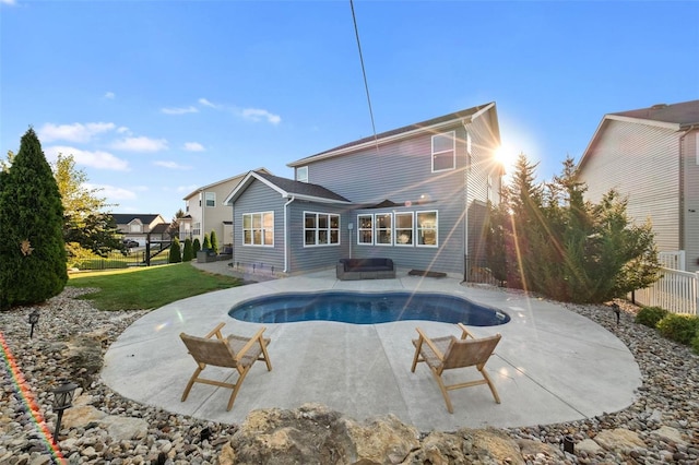 view of swimming pool featuring a patio and a lawn