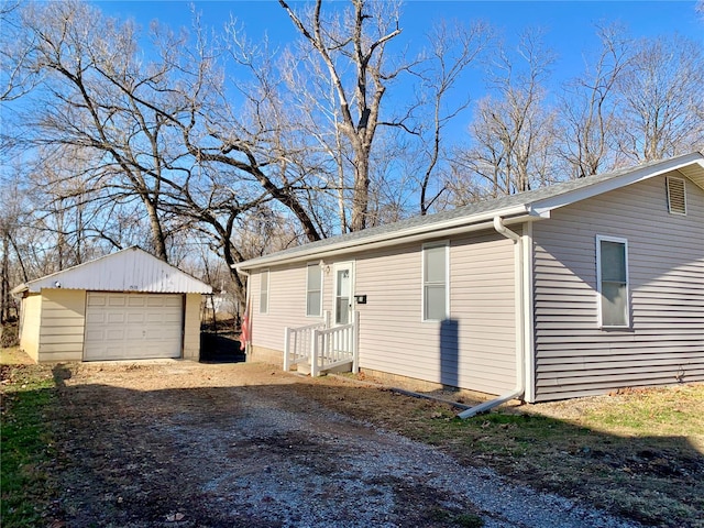 view of property exterior featuring an outdoor structure and a garage