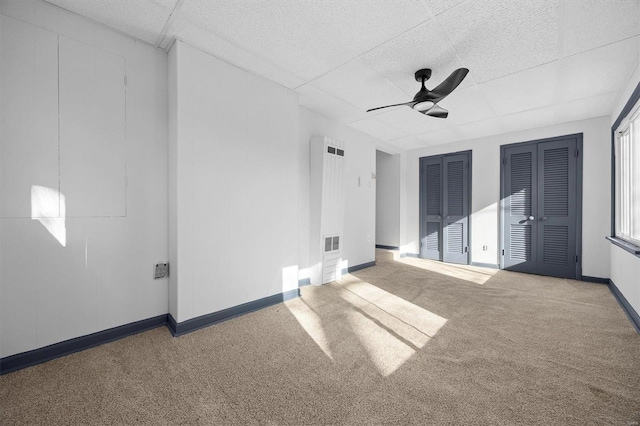 spare room featuring ceiling fan and carpet floors